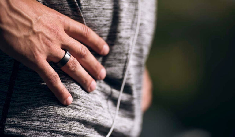 persons hand with ring resting on hip